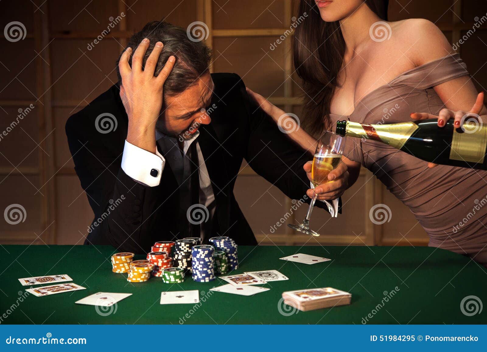 Photo Emotional Man Loser In Poker And Ladies Pours Him A Glas pic