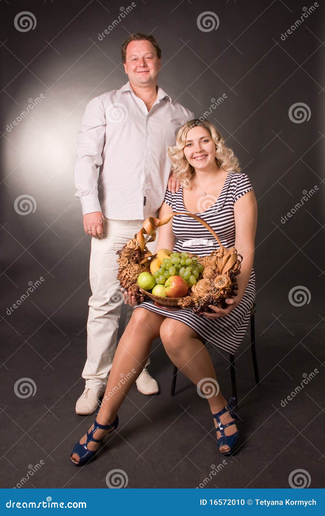 Photo of Family Pair with the Basket of Fruit Stock Photo Image of