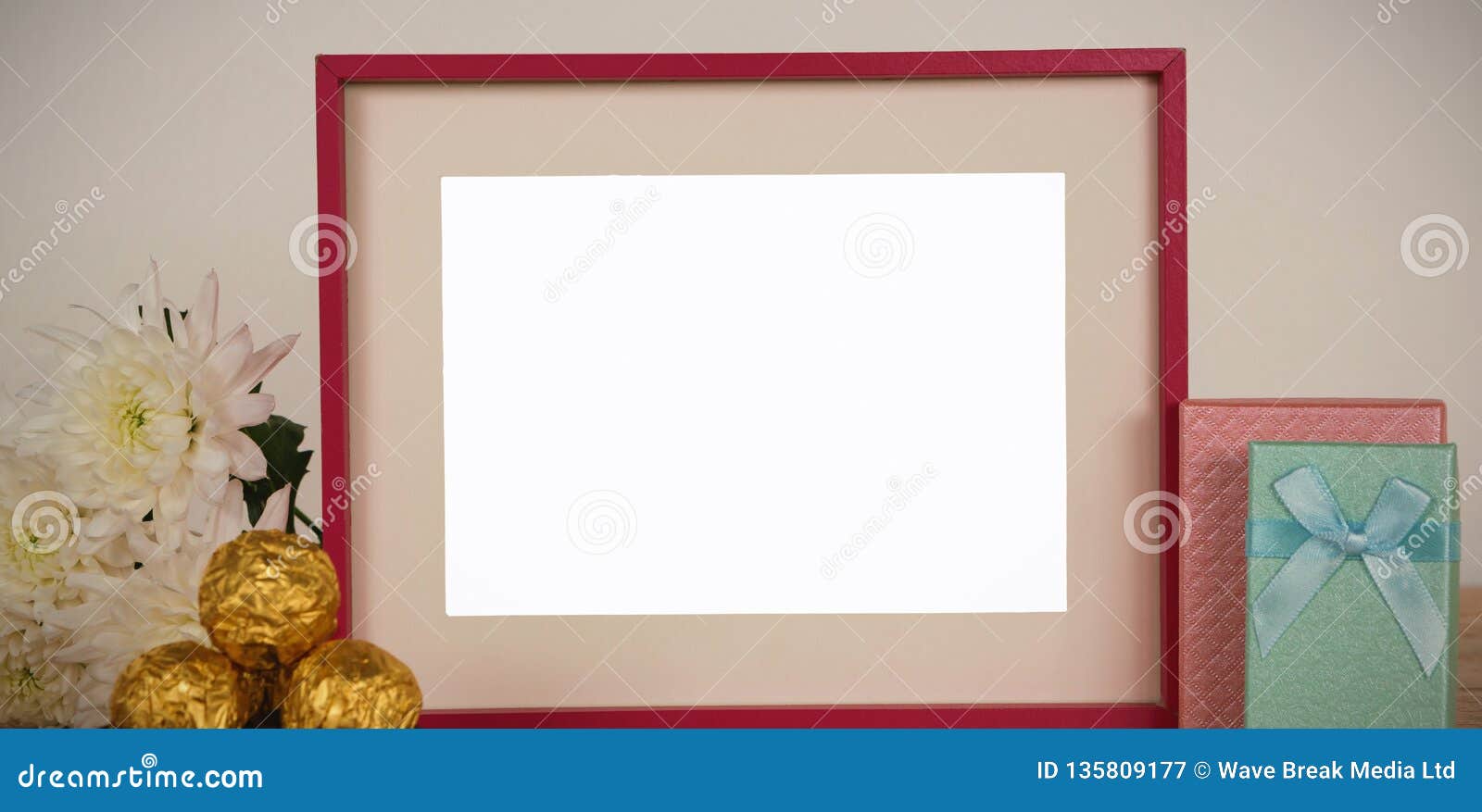 Photo Frame, Flower, Chocolates and Gift Boxes on a Table Stock Image