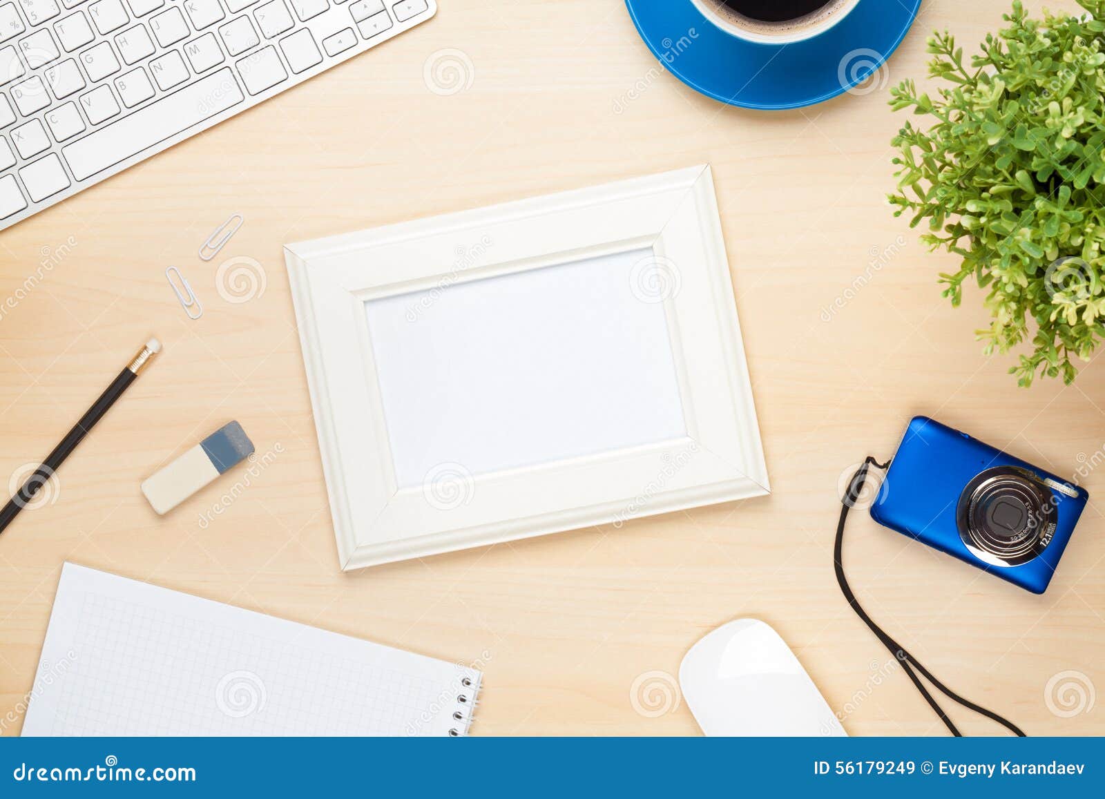 Photo Frame on Office Table with Notepad, Computer and Camera Stock