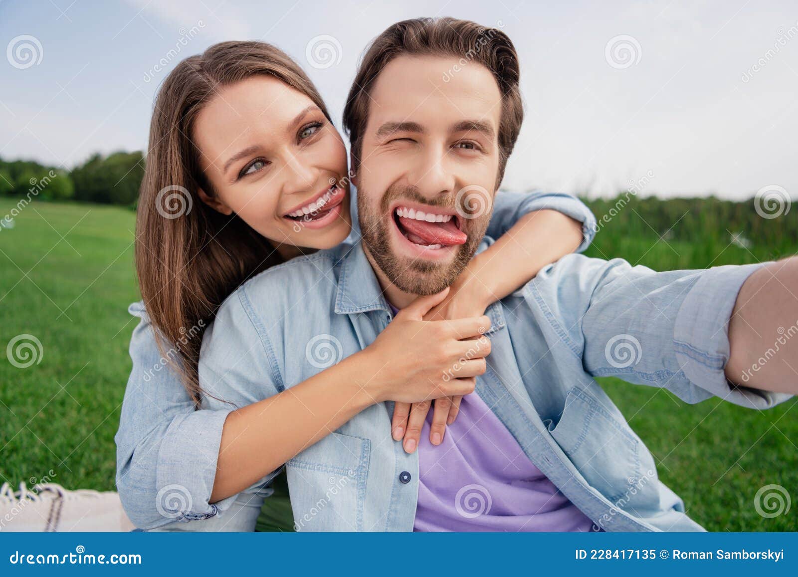 Photo Of Funky Funny Smiling Couple Take Selfie Fooling Around Show