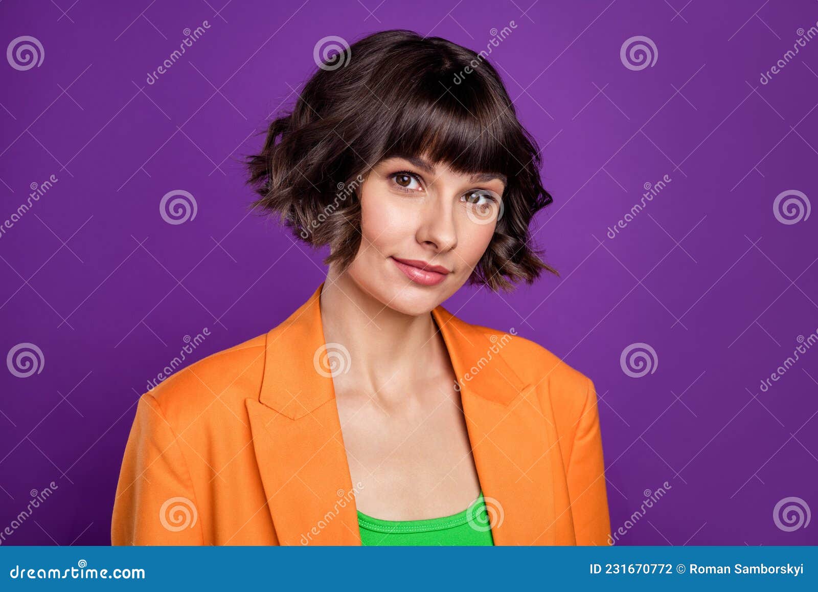Photo of funny charming young woman dressed orange blazer smiling isolated purple color background.