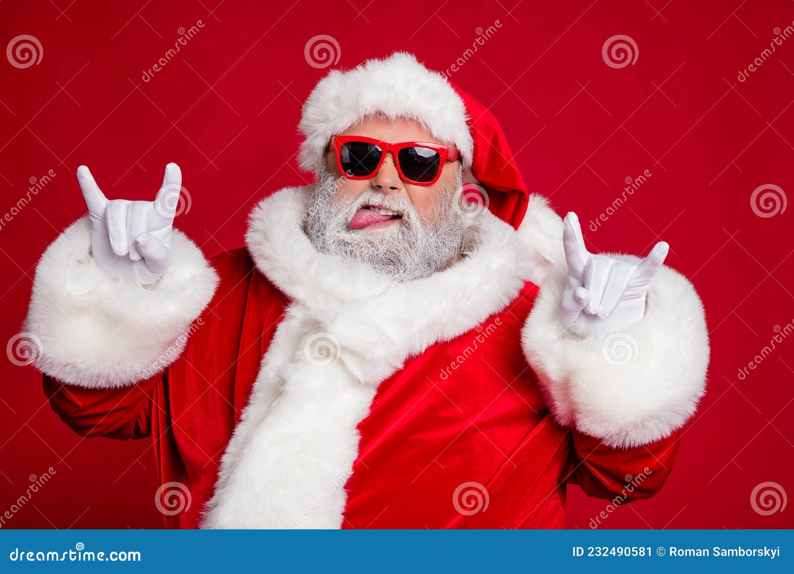 photo of funny crazy rude careless old man show horns protrude tongue wear santa hat costume  red color