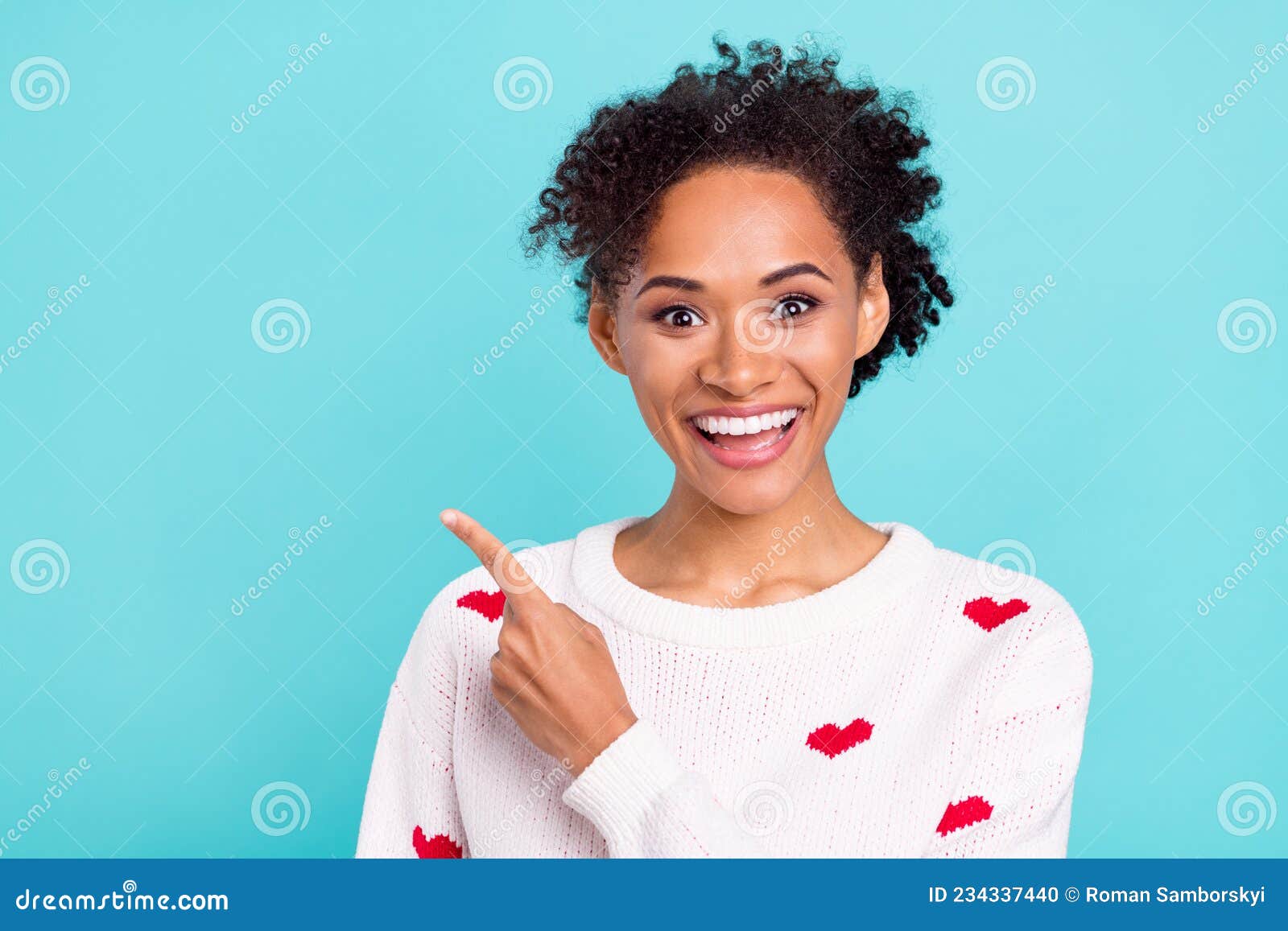 photo of funny excited african lady dressed white sweater pointing finger empty space smiling  blue color