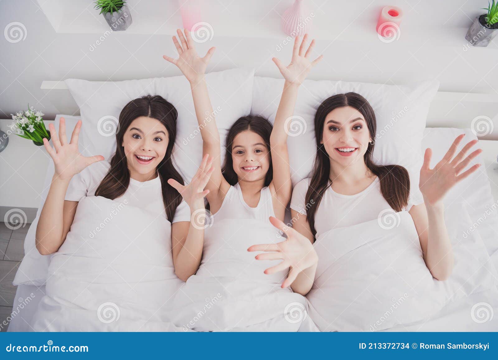 Photo of Funny Excited Three Sisters Sleepwear Rising Arms Hands Lying Bed  Having Rest Inside Indoors Home Room Stock Photo - Image of relax, shock:  213372734