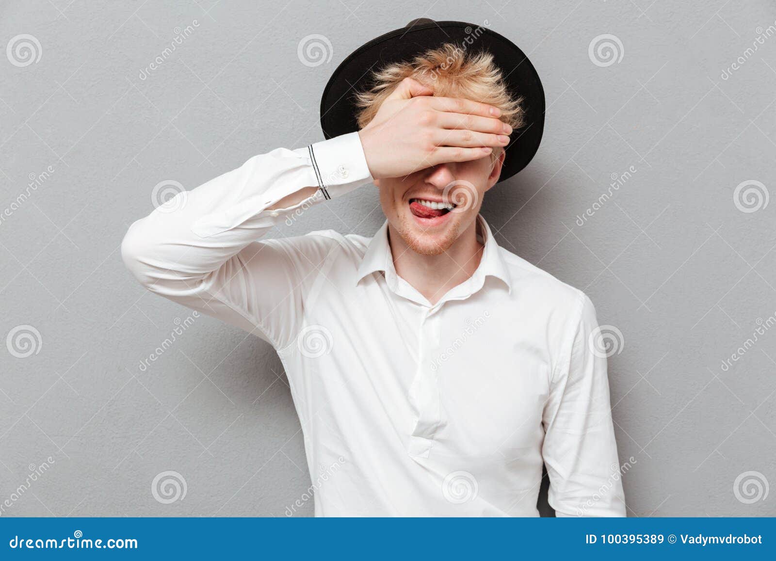 Cheerful Young Caucasian Man Covering Eyes with Hand Stock Image ...