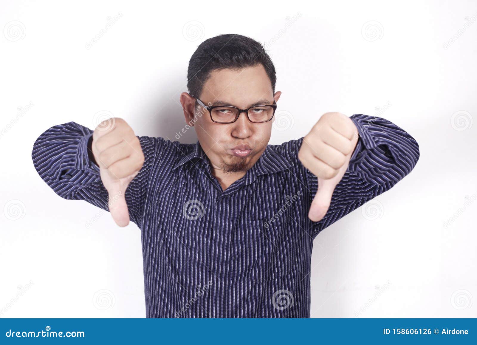 young man showing thumbs down