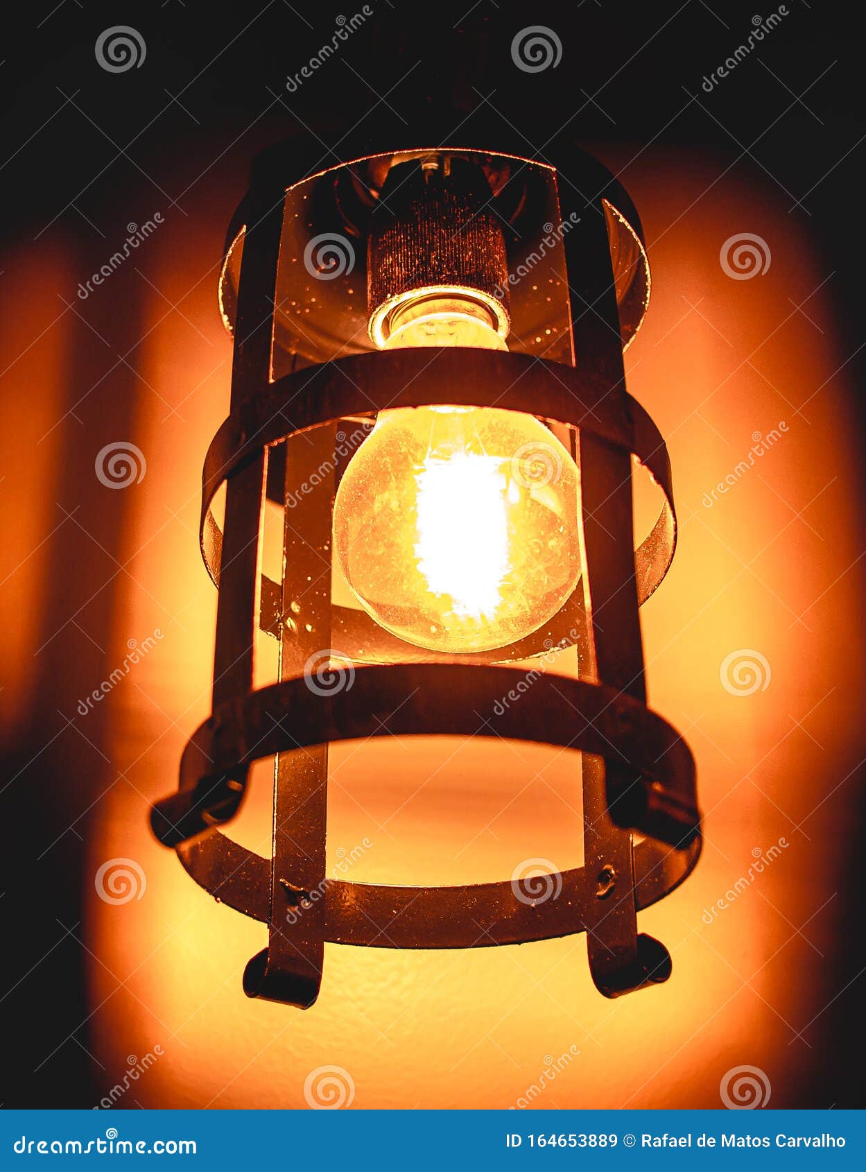 photo of an incandescent lamp light on in rustic support.