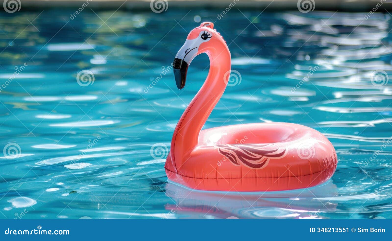a photo of an inflatable pink flamingo floating
