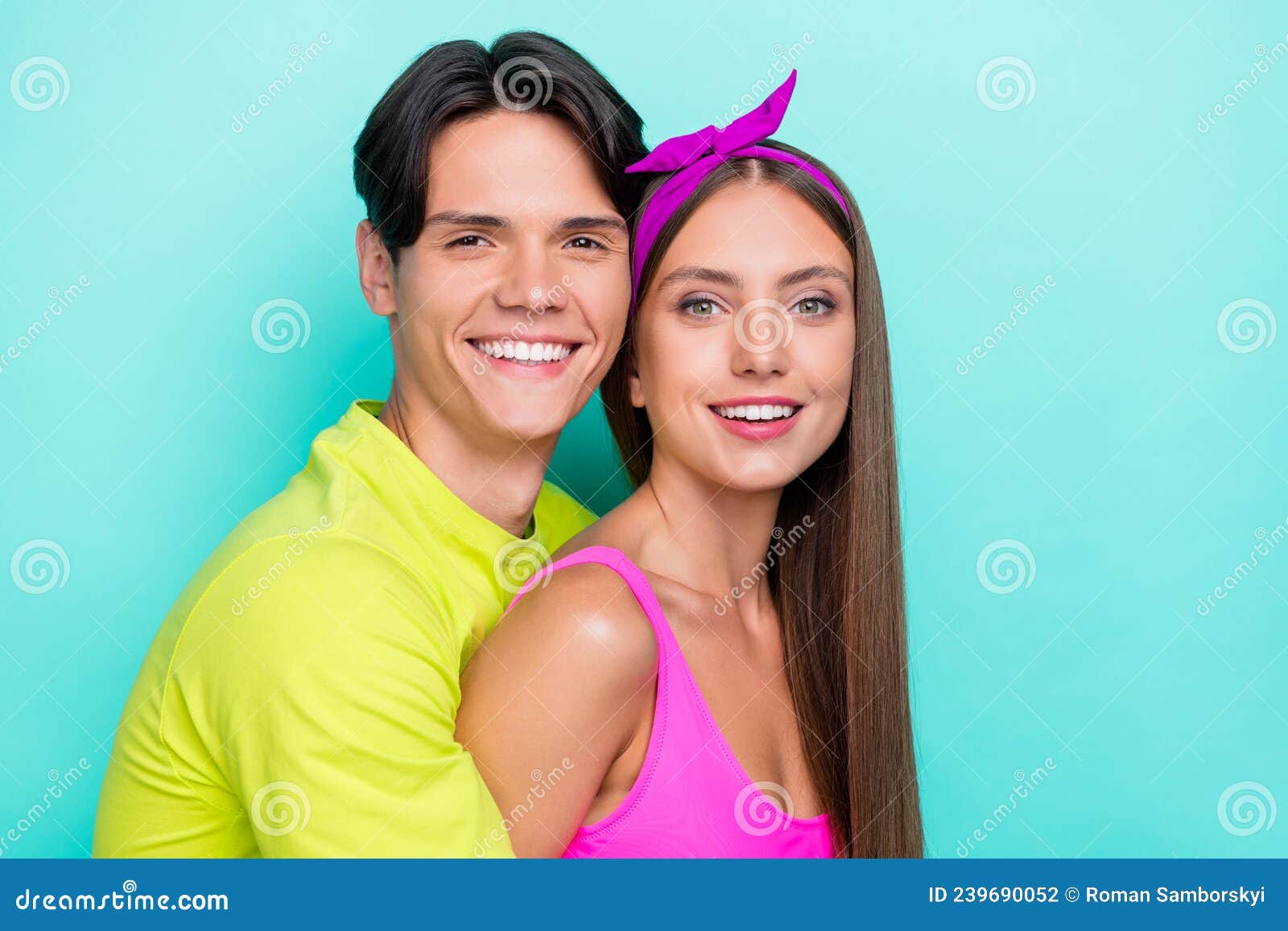 Photo Of Lovely Brunette Millennial Couple Hug Wear Yellow Pink T Shirts Isolated On Teal Color