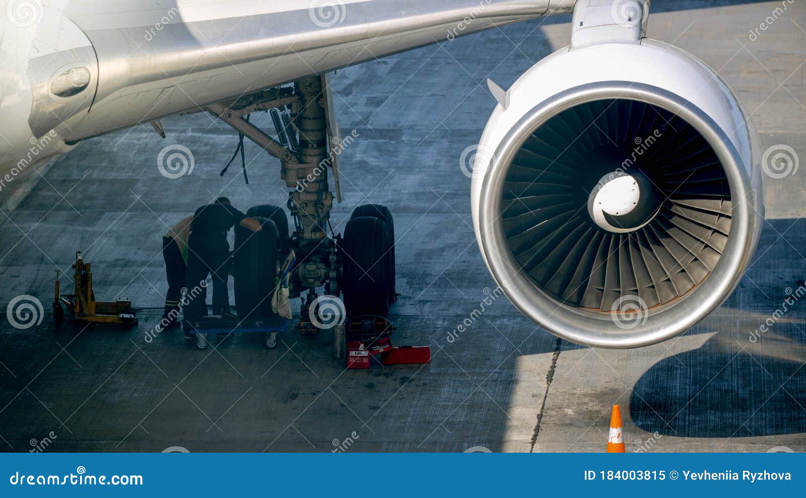 Photo of Maintenace Ground Crew Checking Airplane Chassis before Flight