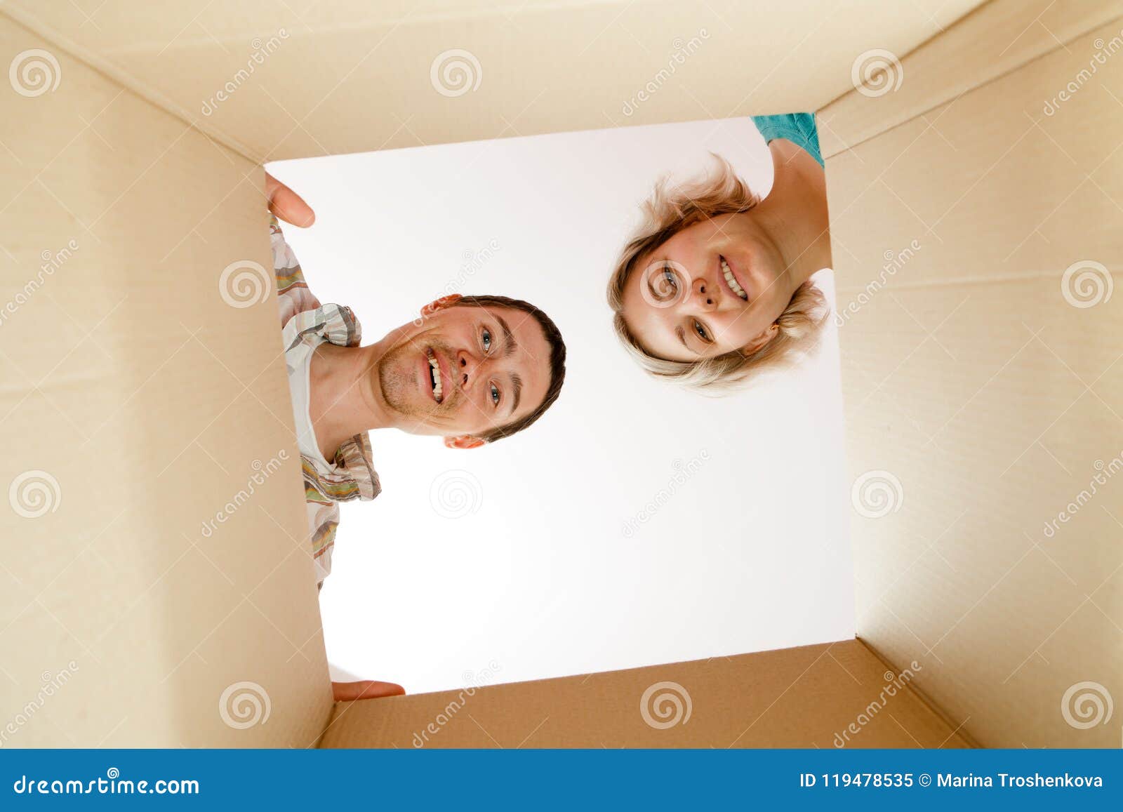 photo of man and woman peering into cardboard box