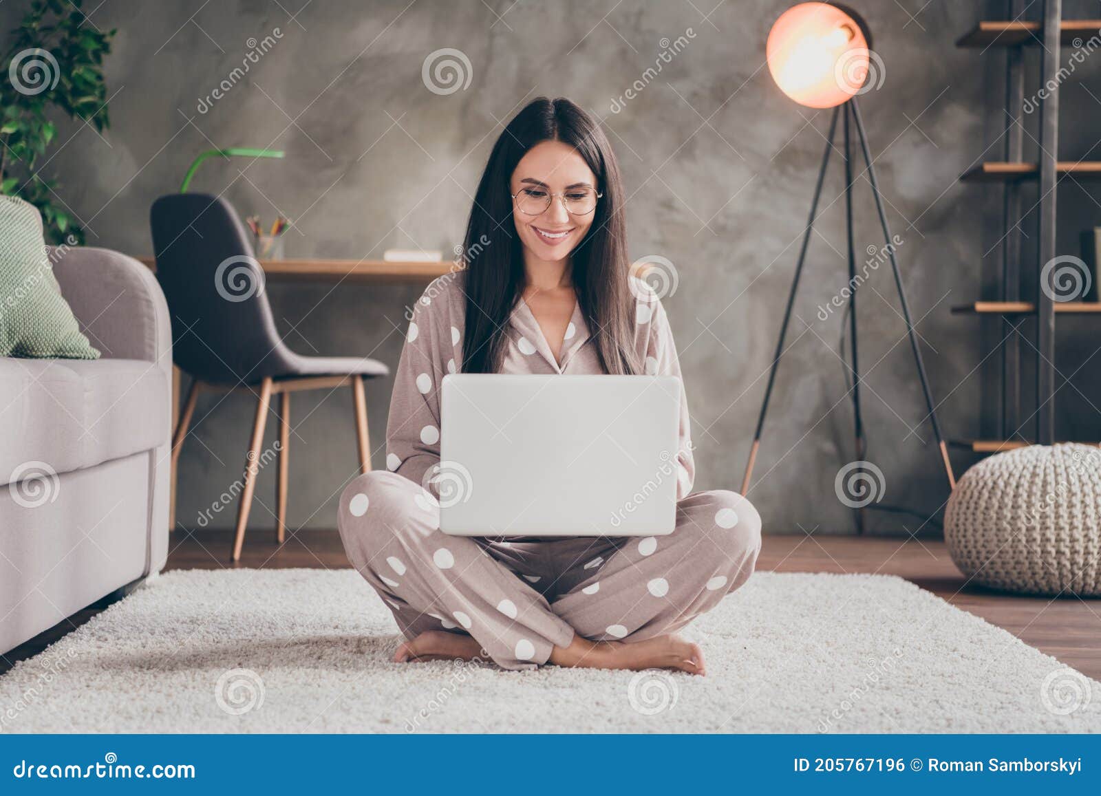 photo of nice sweet girl sit on carpet type laptop wear spectacles pijama at home