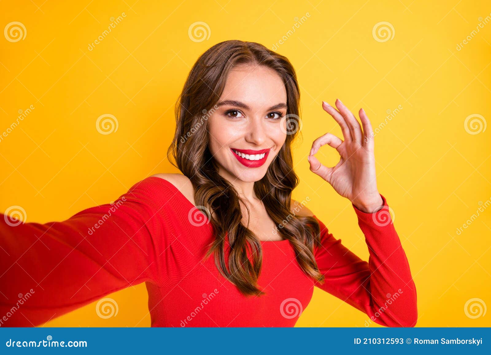 photo portrait of cheerful girl smiling taking selfie showing okay approval sign fingers smiling  on vivid