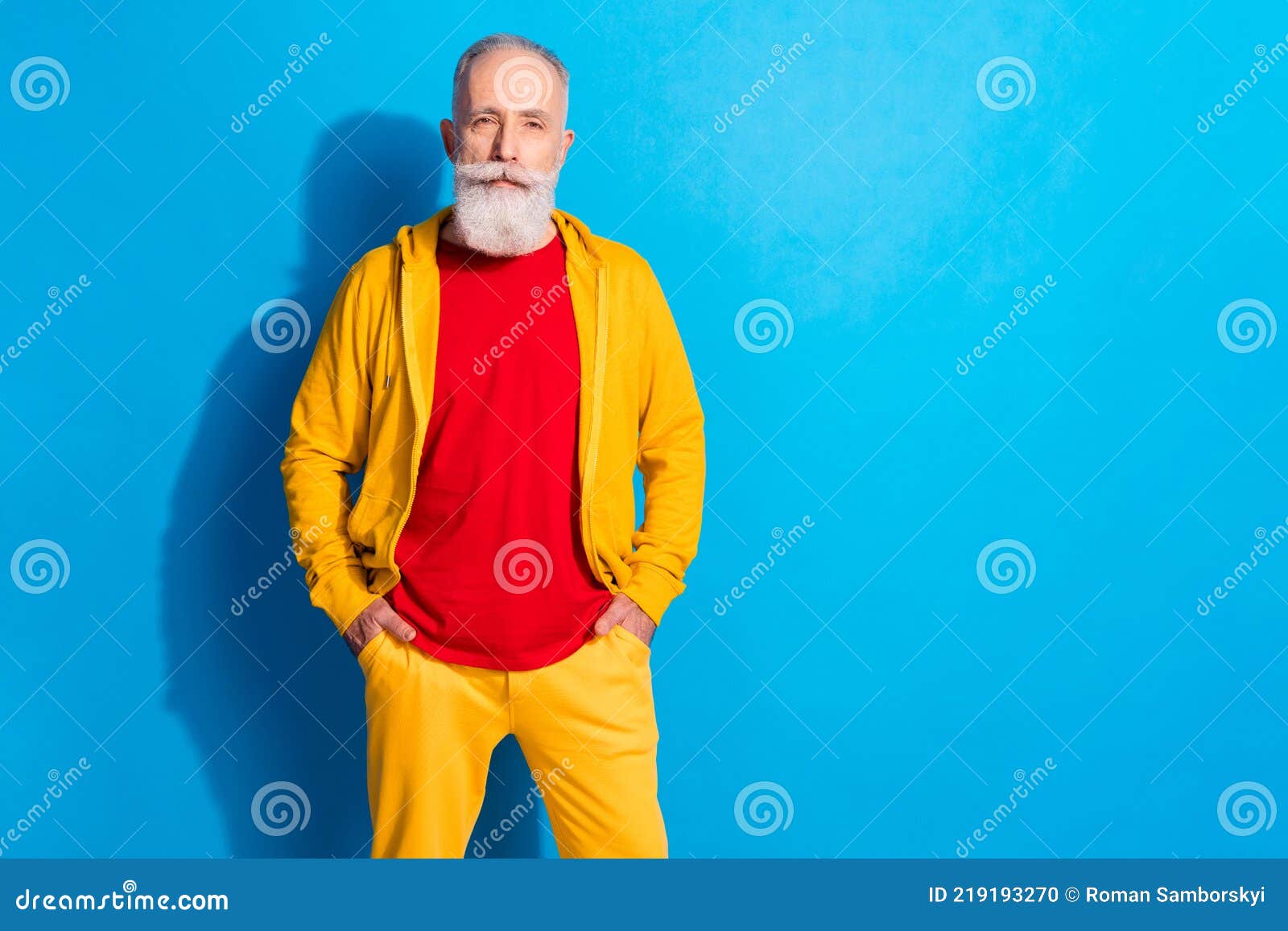 Photo Portrait of Old Man Wearing Yellow Tracksuit Isolated on