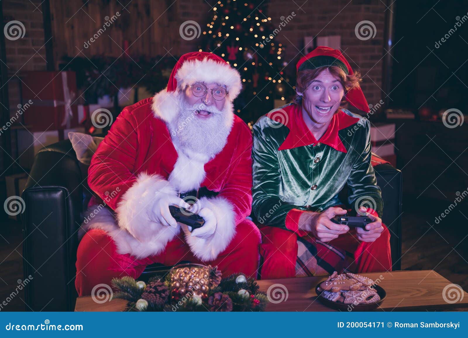 Photo Portrait of Santa Claus and Elf Playing Videogames Holding
