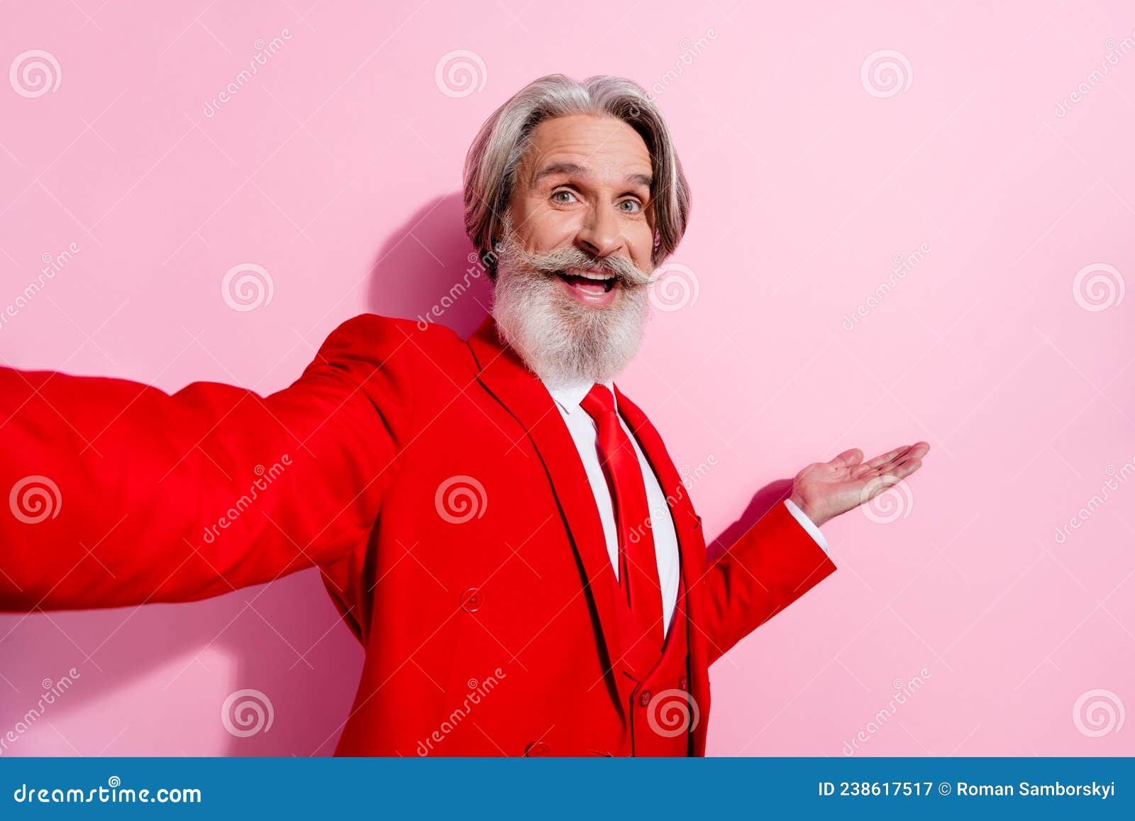photo of pretty excited retired man wear red suit tacking selfie holding arm empty space  pink color background