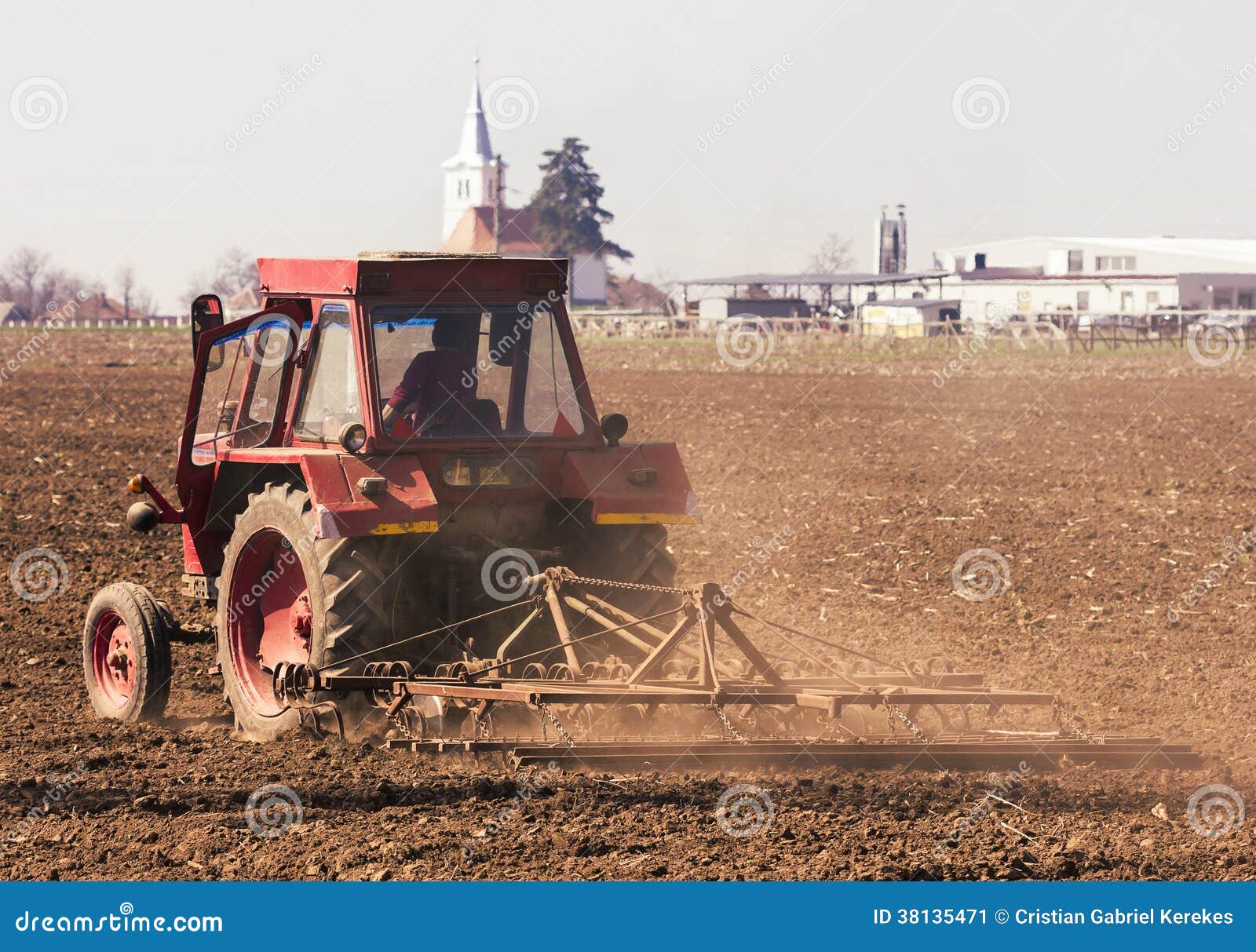 Photo of Red Tractor Working the Ground Stock Image Image of