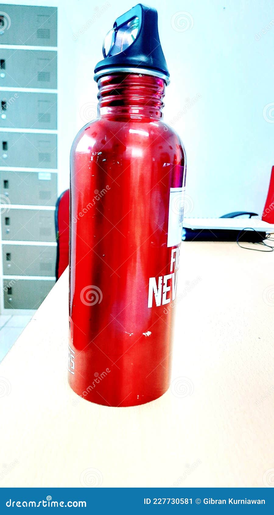 Photo of a Red Water Bottle on the Office Desk Editorial Photo Image