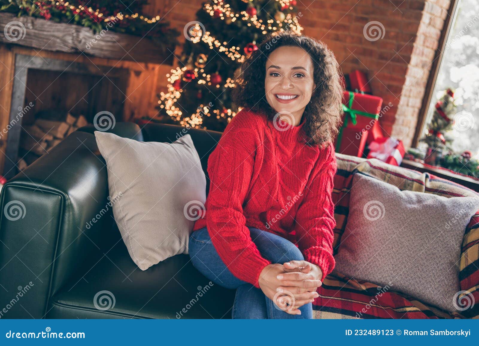 photo of relaxed dreamy inspired lady sit cozy sofa cuddle knee wear sweater in decorated home indoors