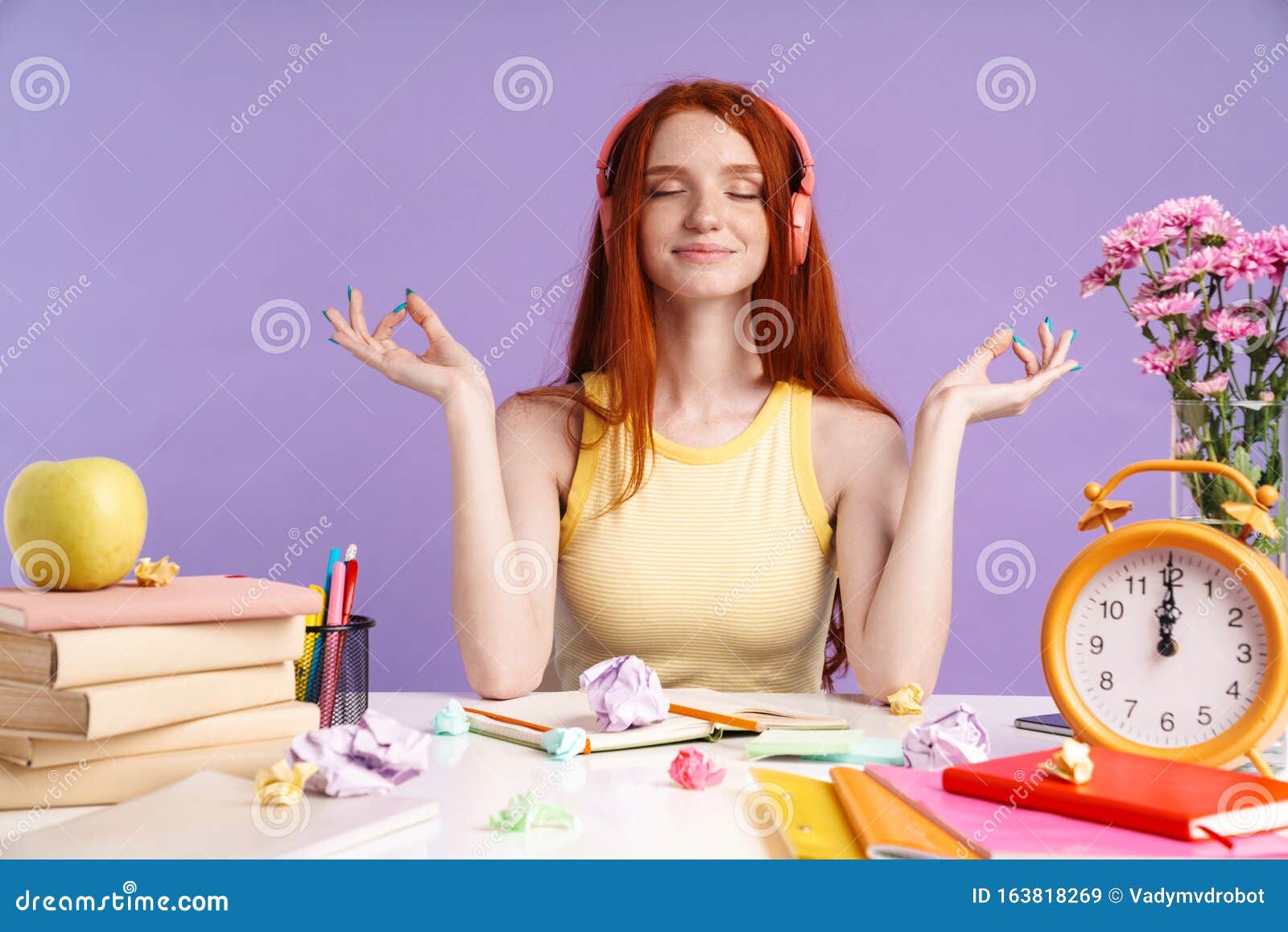 Photo Of Relaxed Student Girl In Headphones Sitting At Desk With