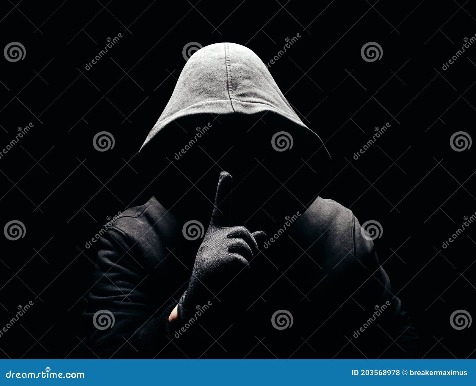 scary man in hood showing silence sign