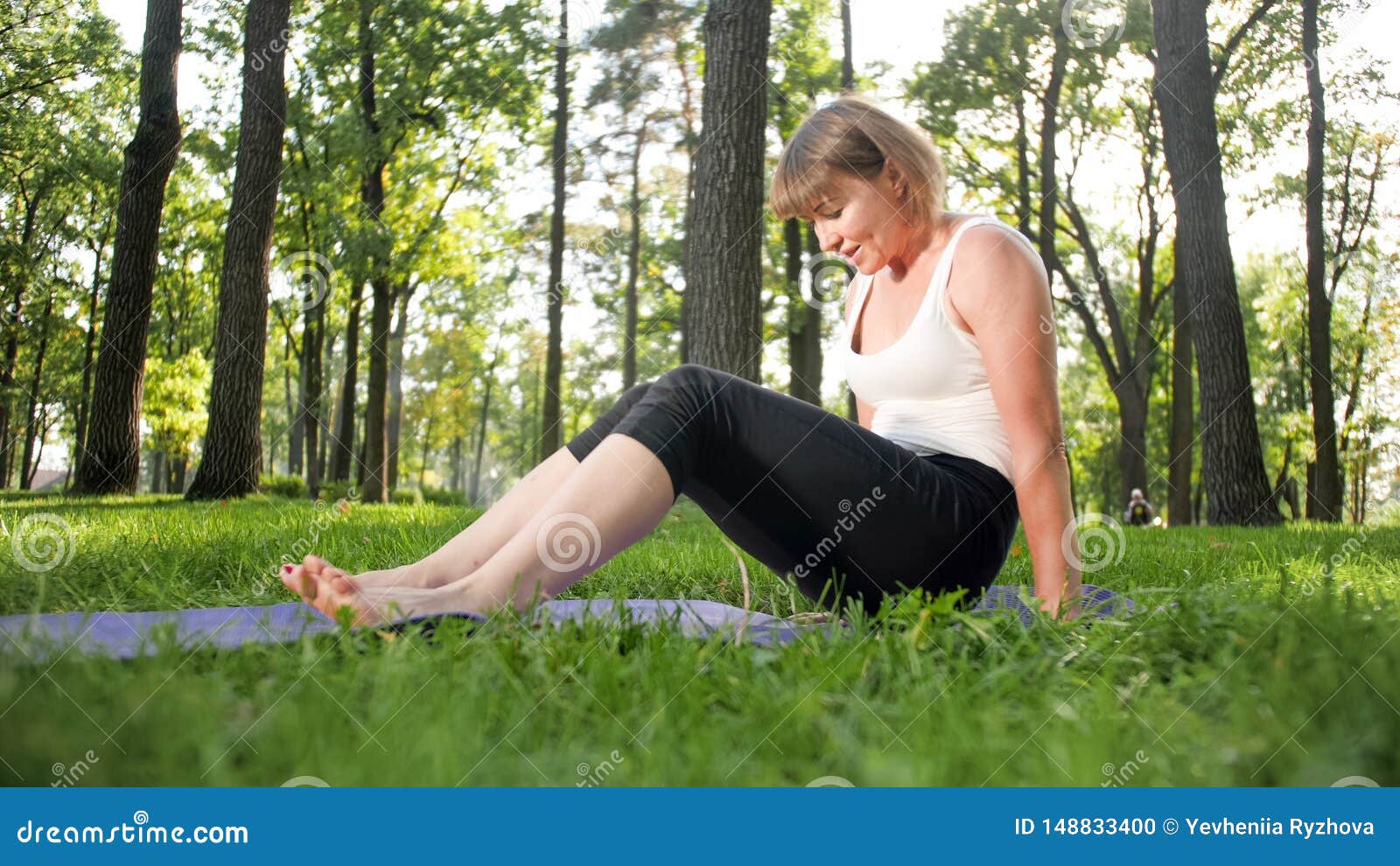 Image of Smiling Middle Aged Woman in Fitness Clothes Doing Stretching ...