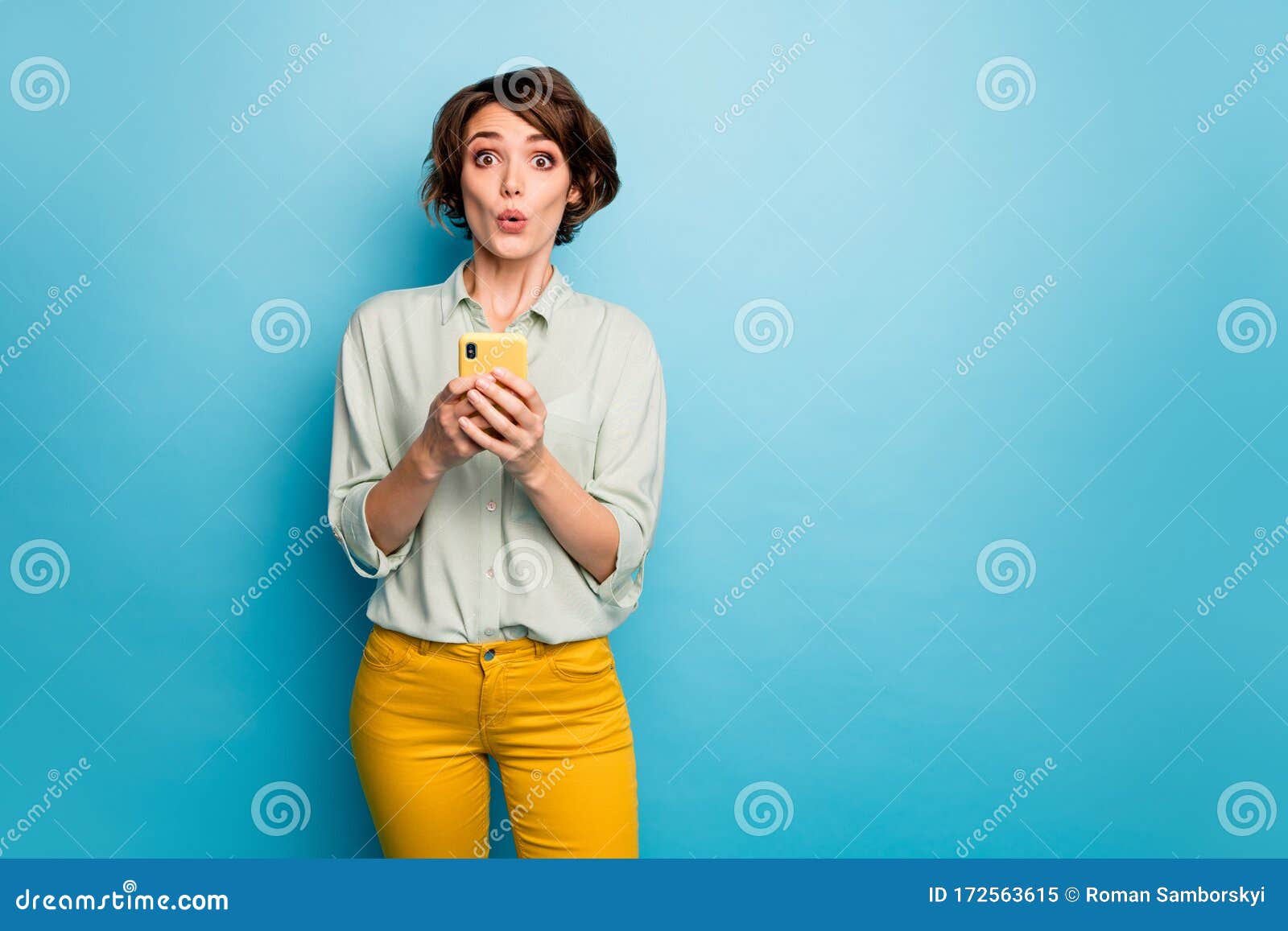 Photo of Speechless Lady Hold Telephone Hands Read New Blog Comments Not  Believe Eyes Terrified Wear Casual Green Shirt Stock Image - Image of news,  network: 172563615