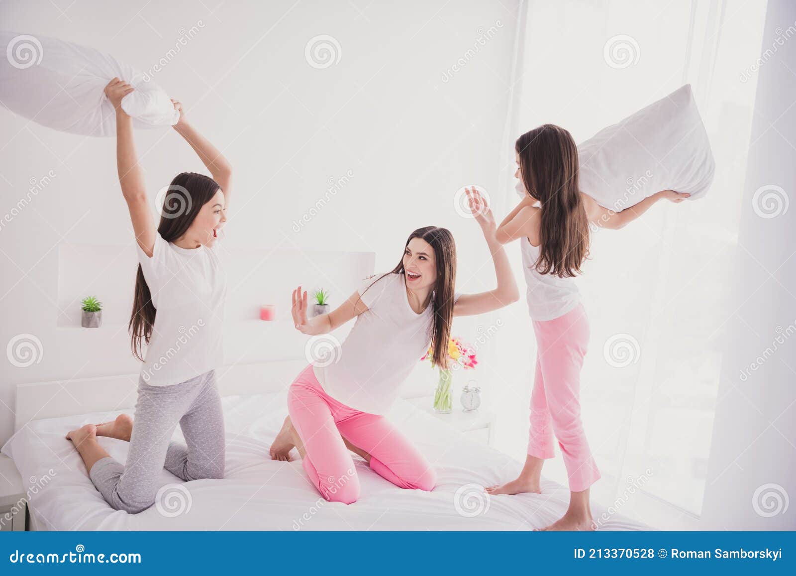 Photo of Sweet Funny Three Sisters Sleepwear Sitting Bed Pillow Fighting  Smiling Inside Indoors Home Room Stock Photo - Image of little, morning:  213370528