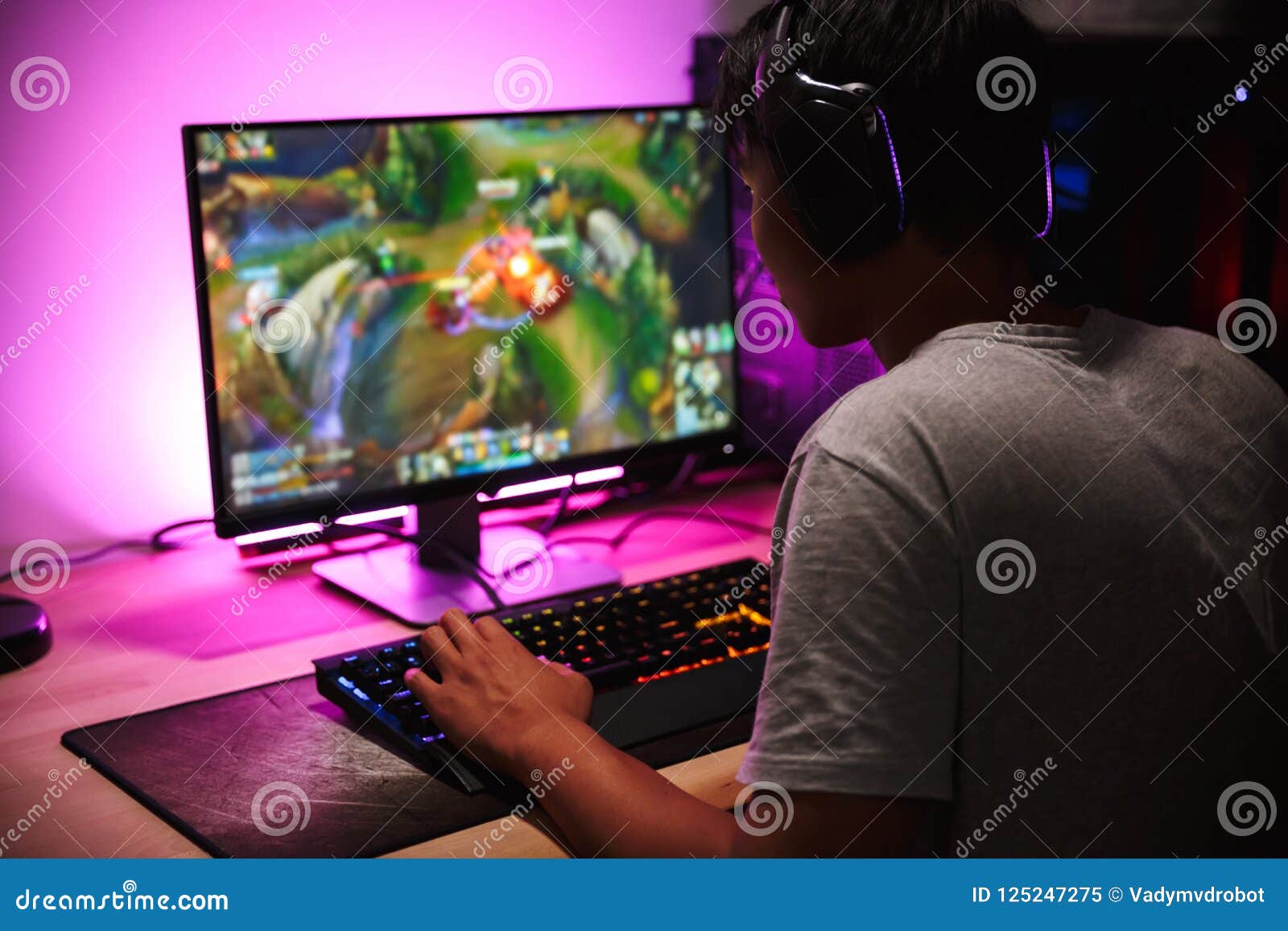 Teenager Boy Online Plays A Computer Game With Headphones And A