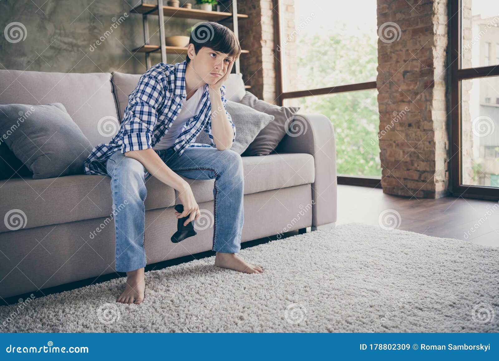 Photo of Teenager School Boy Sit Couch Stay Home Quarantine Time Hold ...