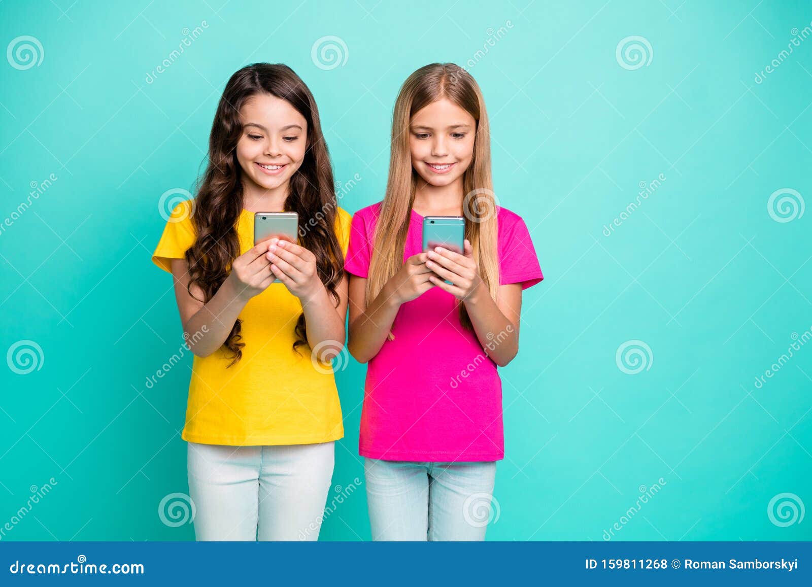 Photo of Two Girls Browsing through Their Newly Bought Phones Typing ...