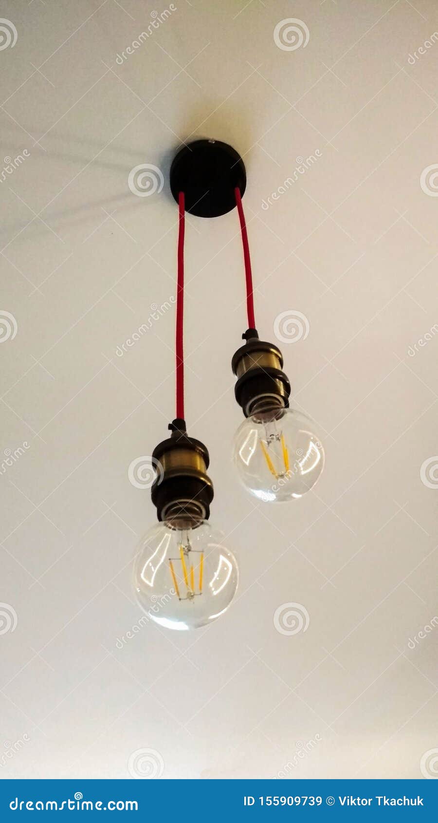 Photo of Two Light Bulbs Hanging from the Ceiling Stock Image Image