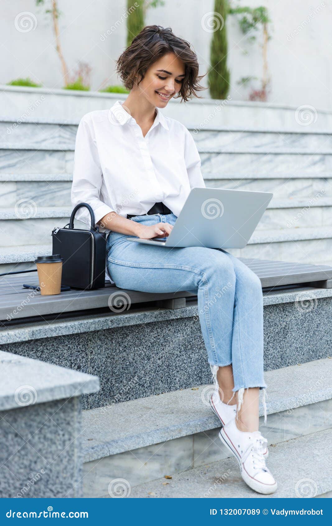 Portrait of a young woman freelancer using laptop computer 