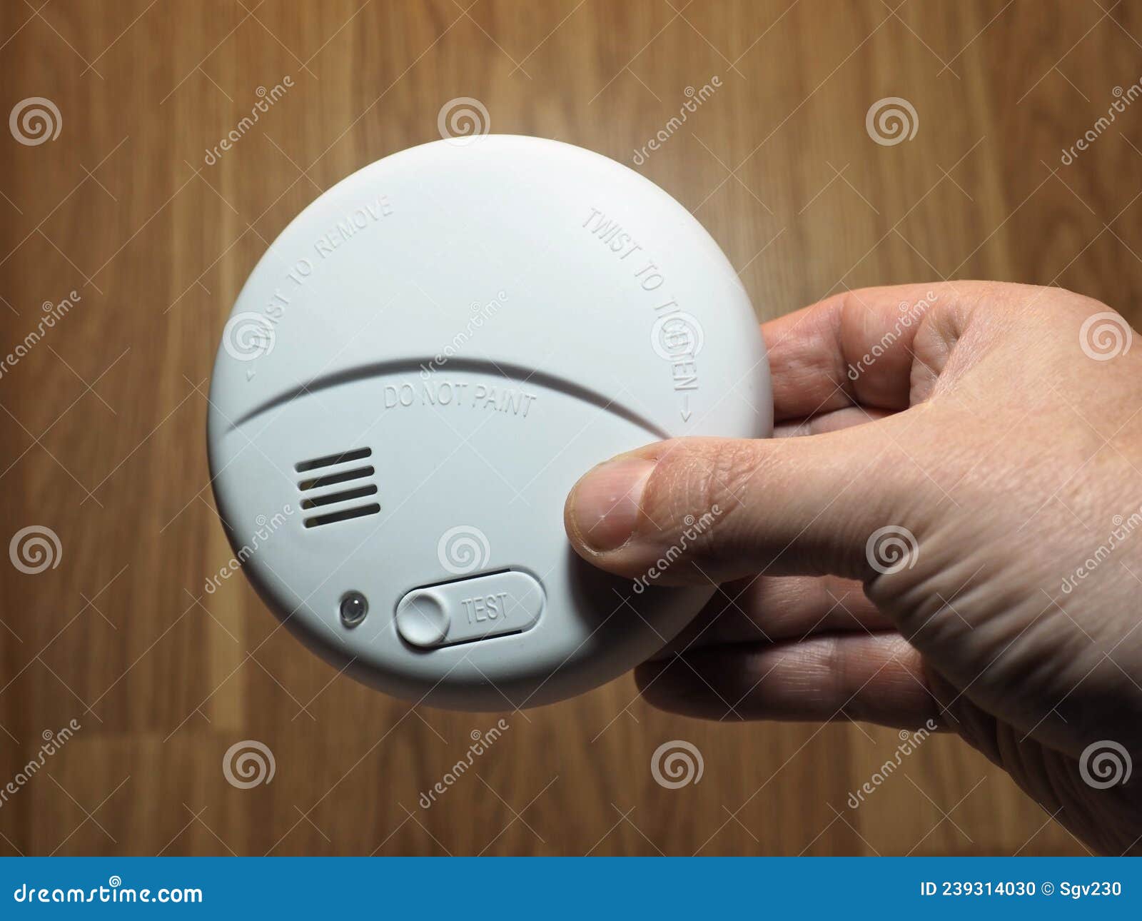 photoelectric smoke detector. hand with smoke detector