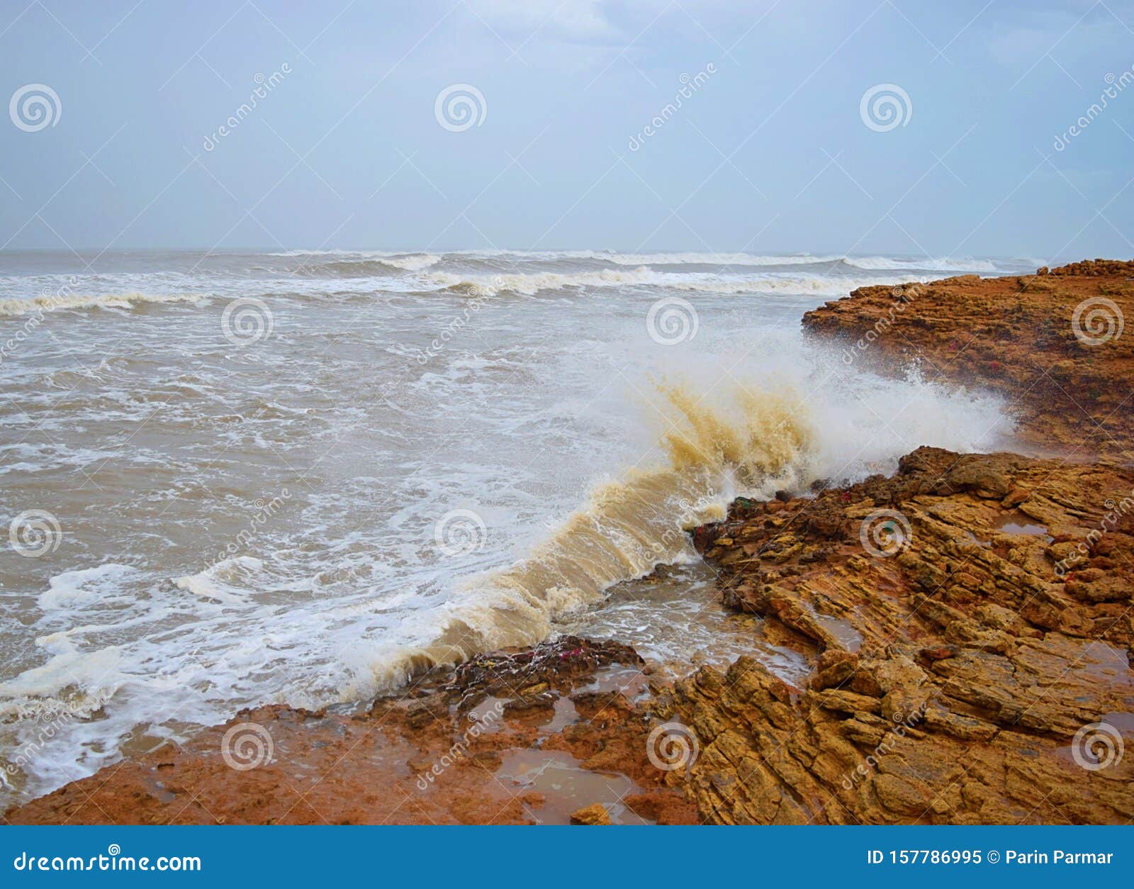 Sea Wave Striking With Rock Cliff On Shore And Sprinkle Of Water ...