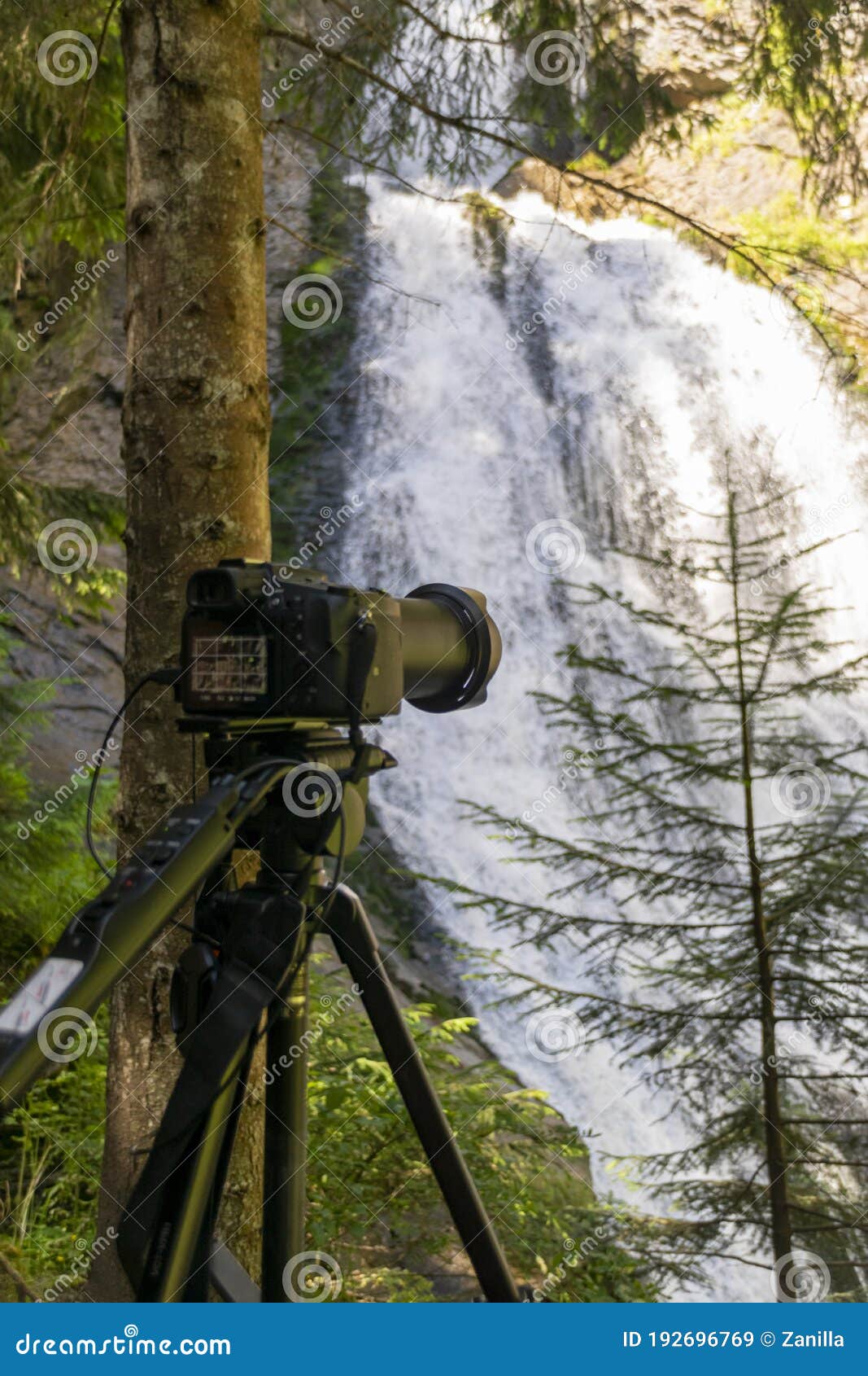 Photographer Equipment Near Waterfall Deep into Mountains Stock Image