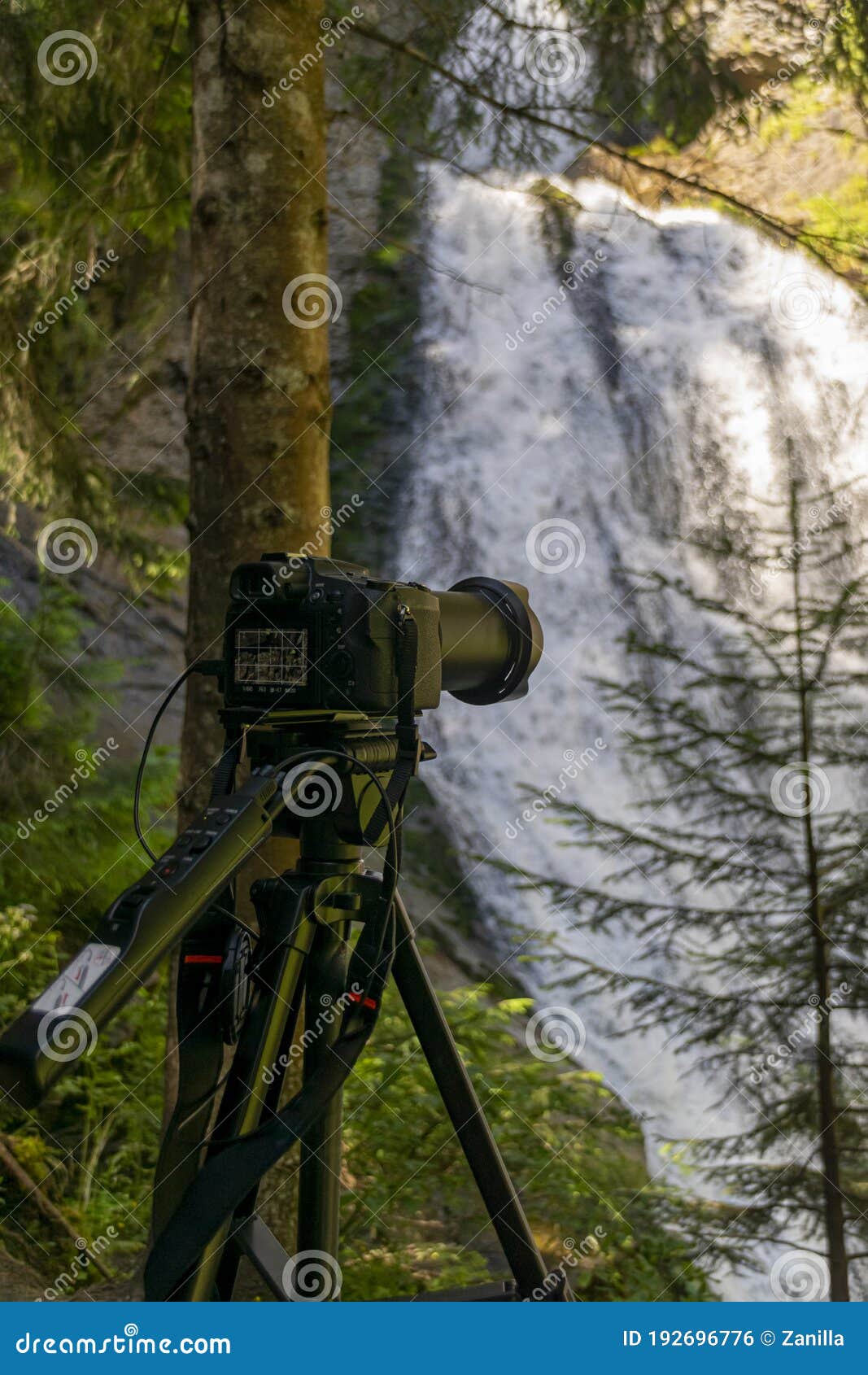 Photographer Equipment Near Waterfall Deep into Mountains Stock Photo