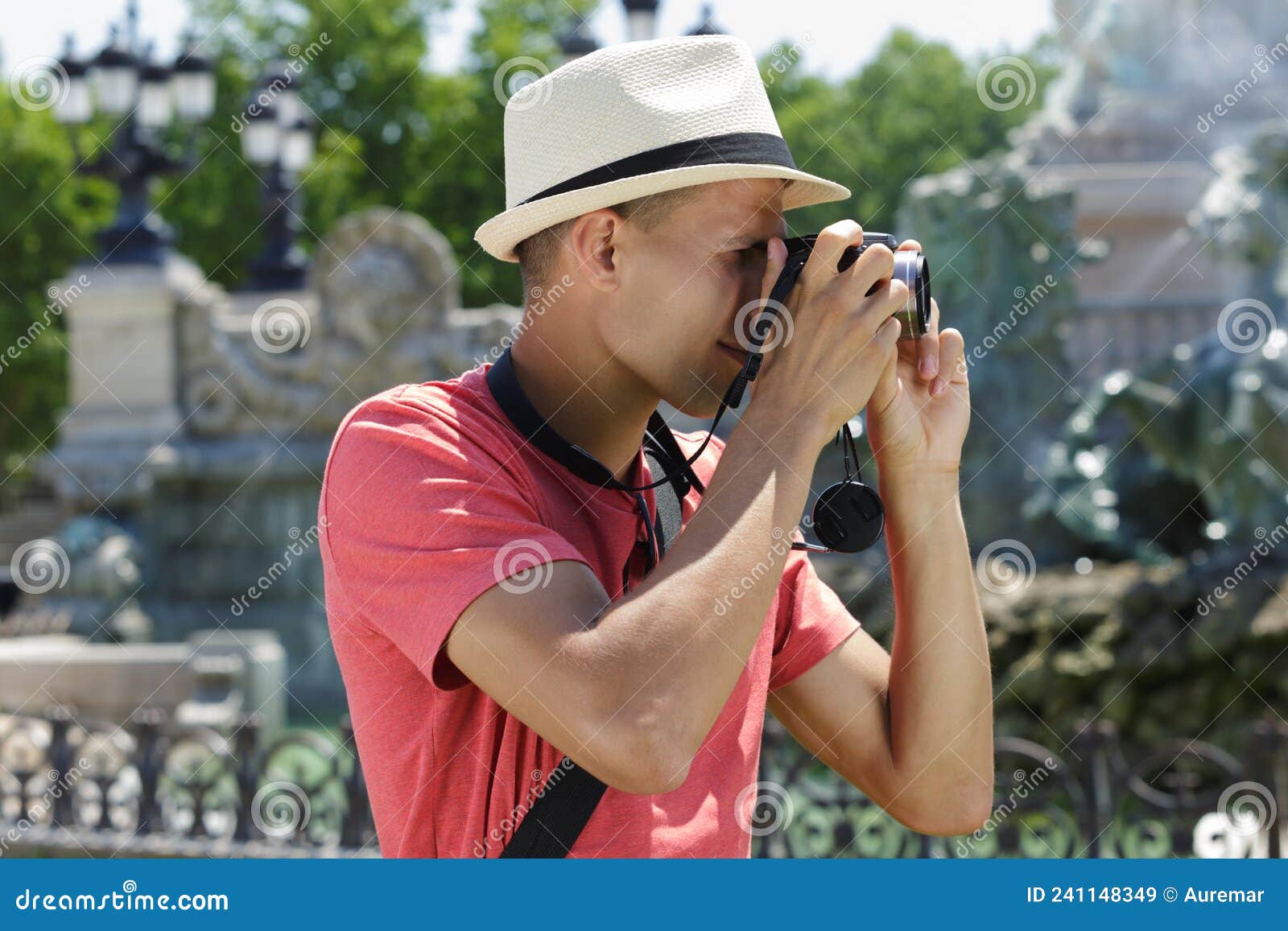 photographer hold dsrl camera in hands talking pictures outdoors