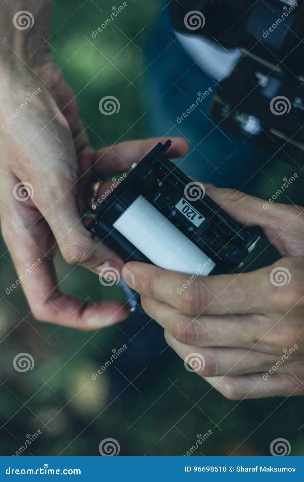 Photographer Loading Medium Format Film into the Film Back Stock Photo