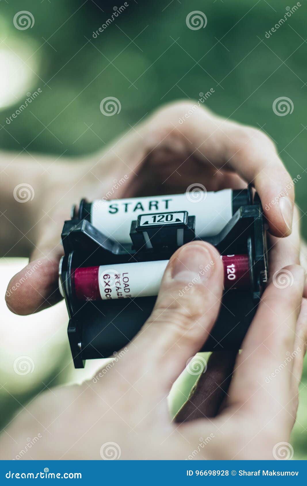 Photographer Loading Medium Format Film into the Film Back Stock Photo