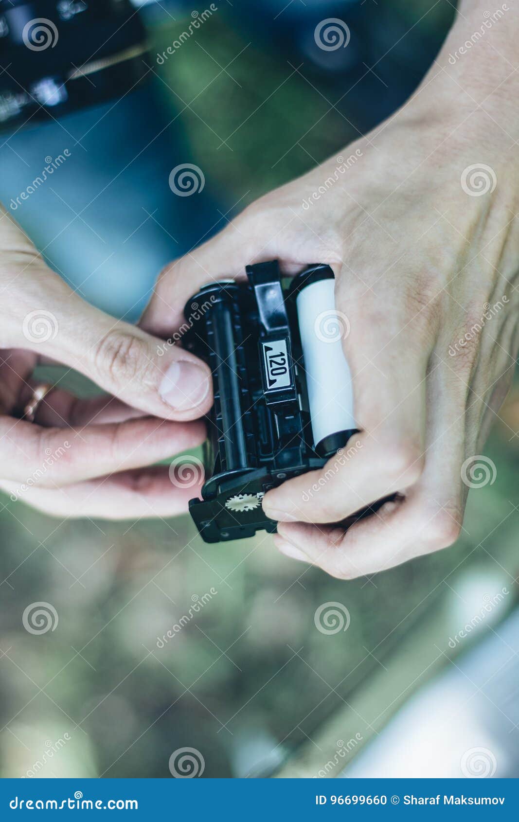 Photographer Loading Medium Format Film into the Film Back Stock Photo