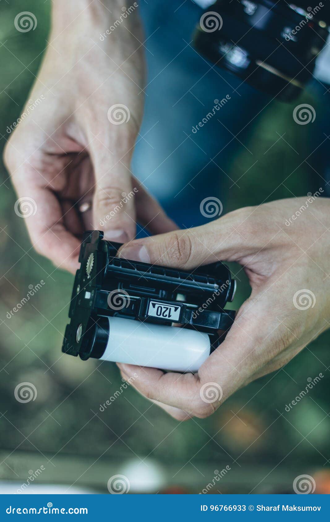 Photographer Loading Medium Format Film into the Film Back Stock Image