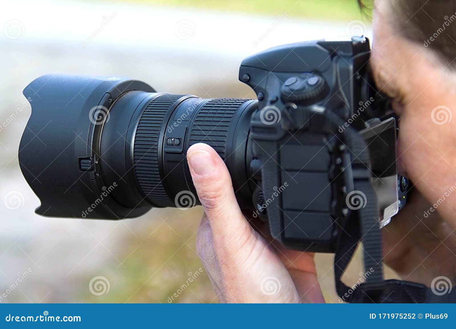 Photographer Looks in the Viewfinder of the Camera Closeup Stock Photo
