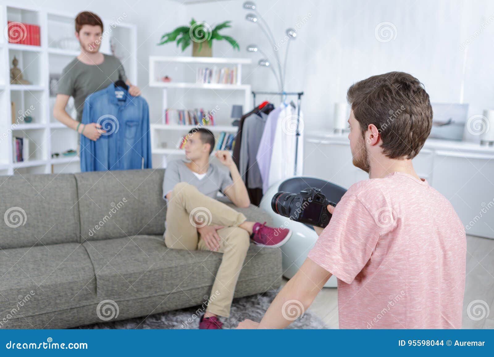Photographer in Photo Studio with Model and Assistant Stock Photo