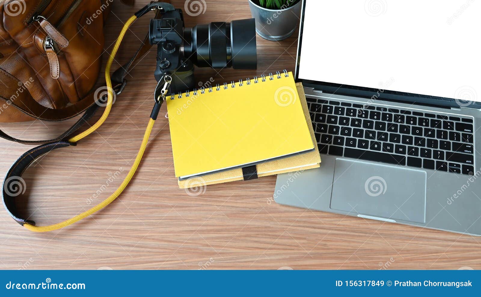 Photographer Table with Camera and Lens, Camera Bag, Laptop Computer