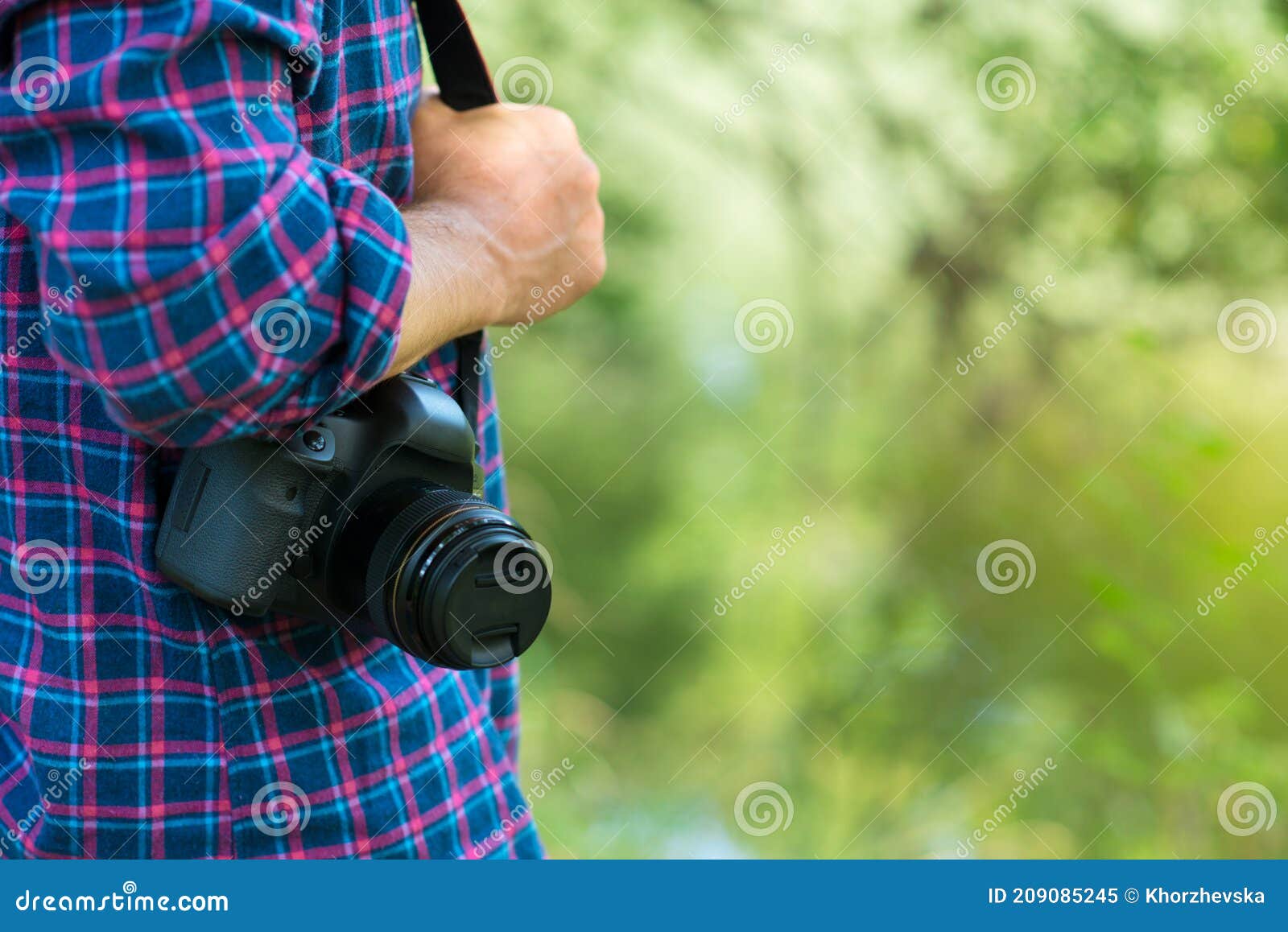 photographer or traveler concept. photographer holding digital camera in his hands with copy space
