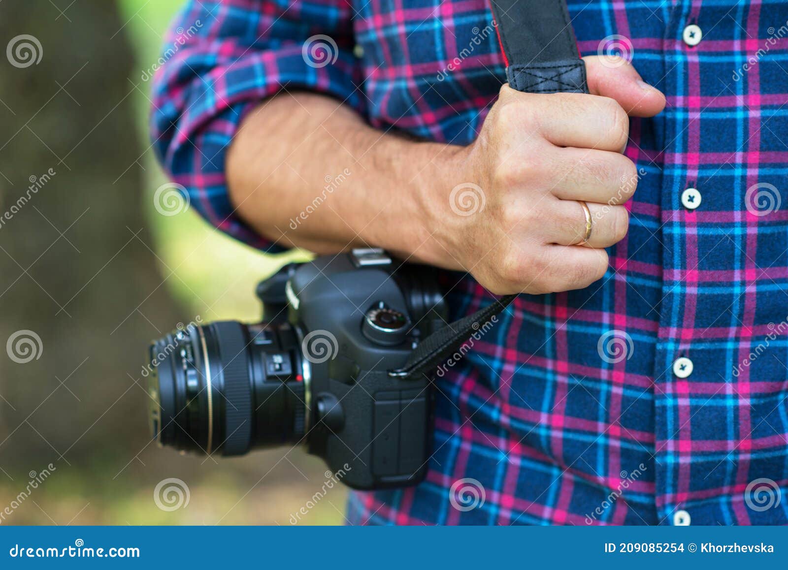 photographer or traveler concept. photographer holding digital camera in his hands