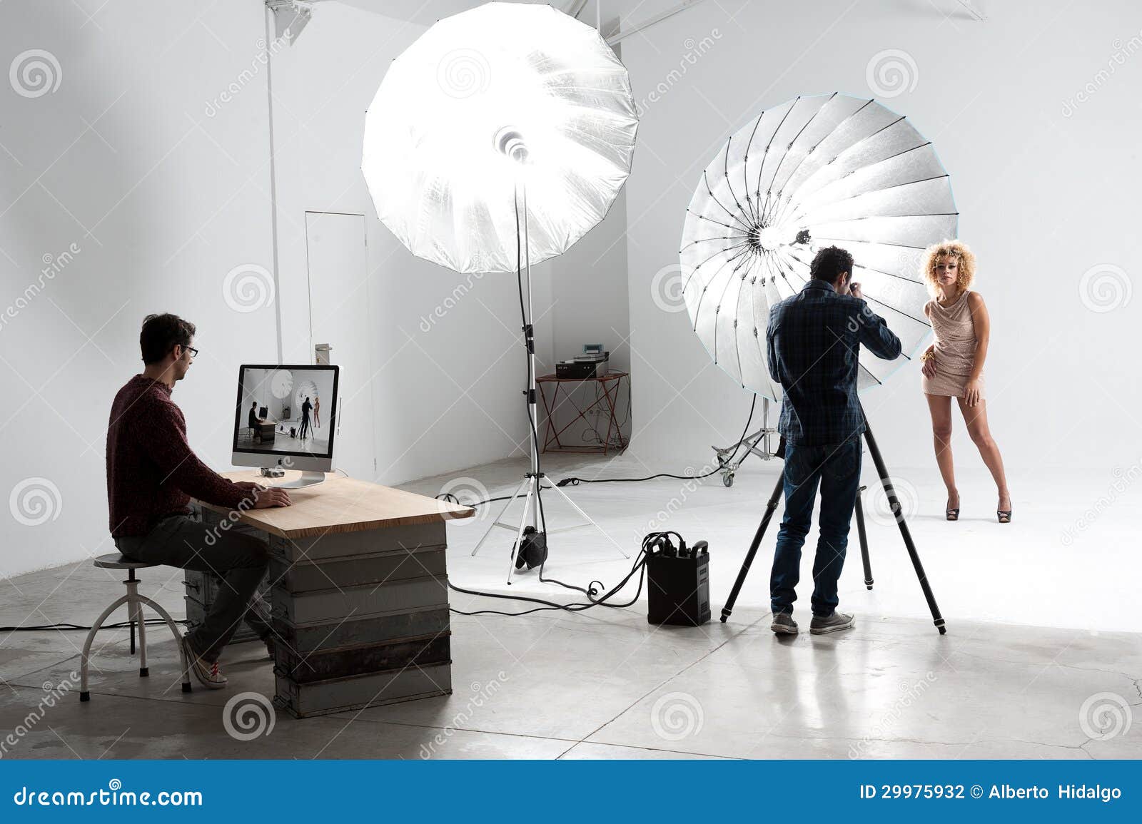 Photographer Working With A Cute Model In A Professional Studio Stock