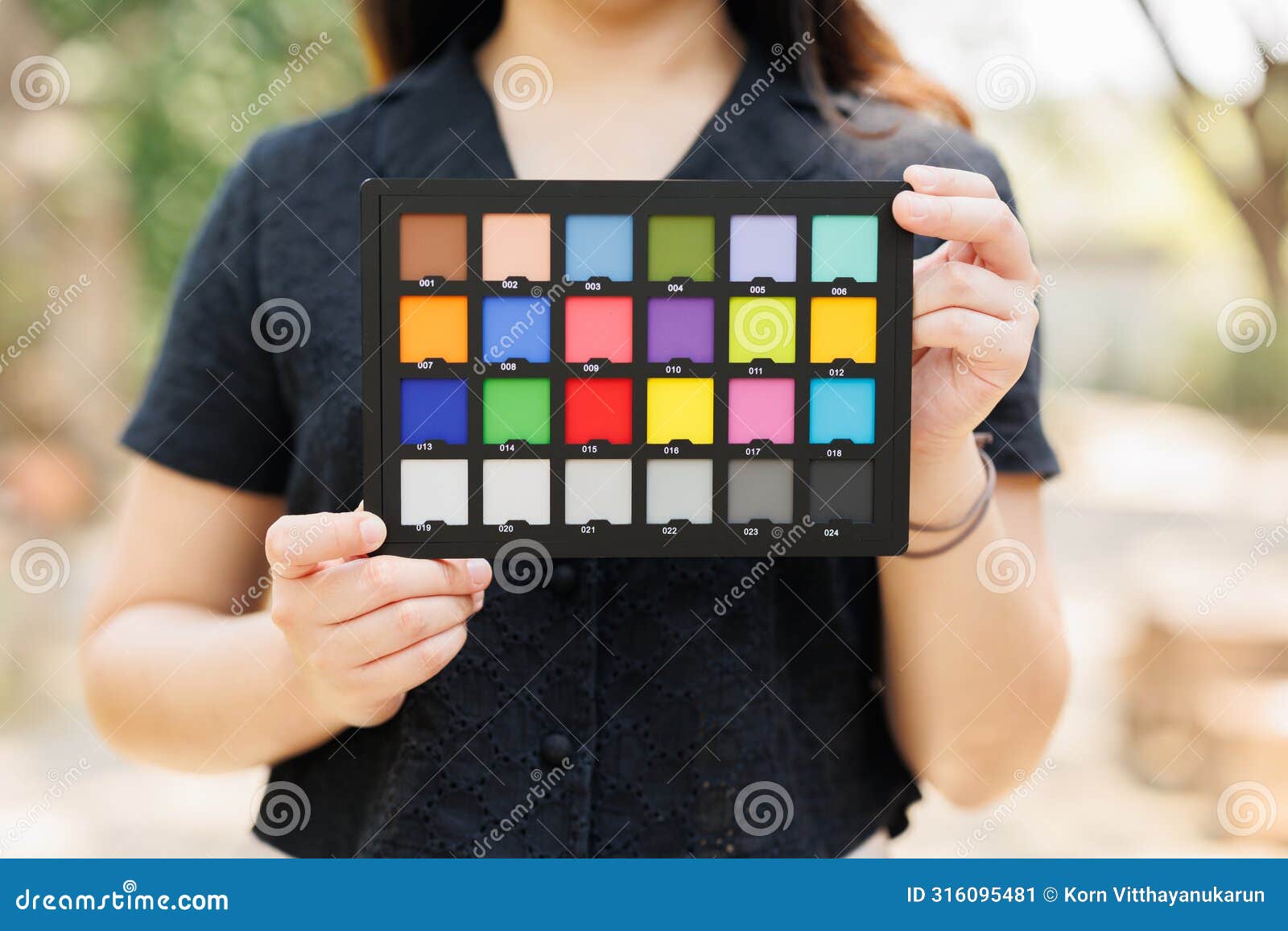 photography model holding color checker board or colors chart for calibrate accurate colors photos or videos